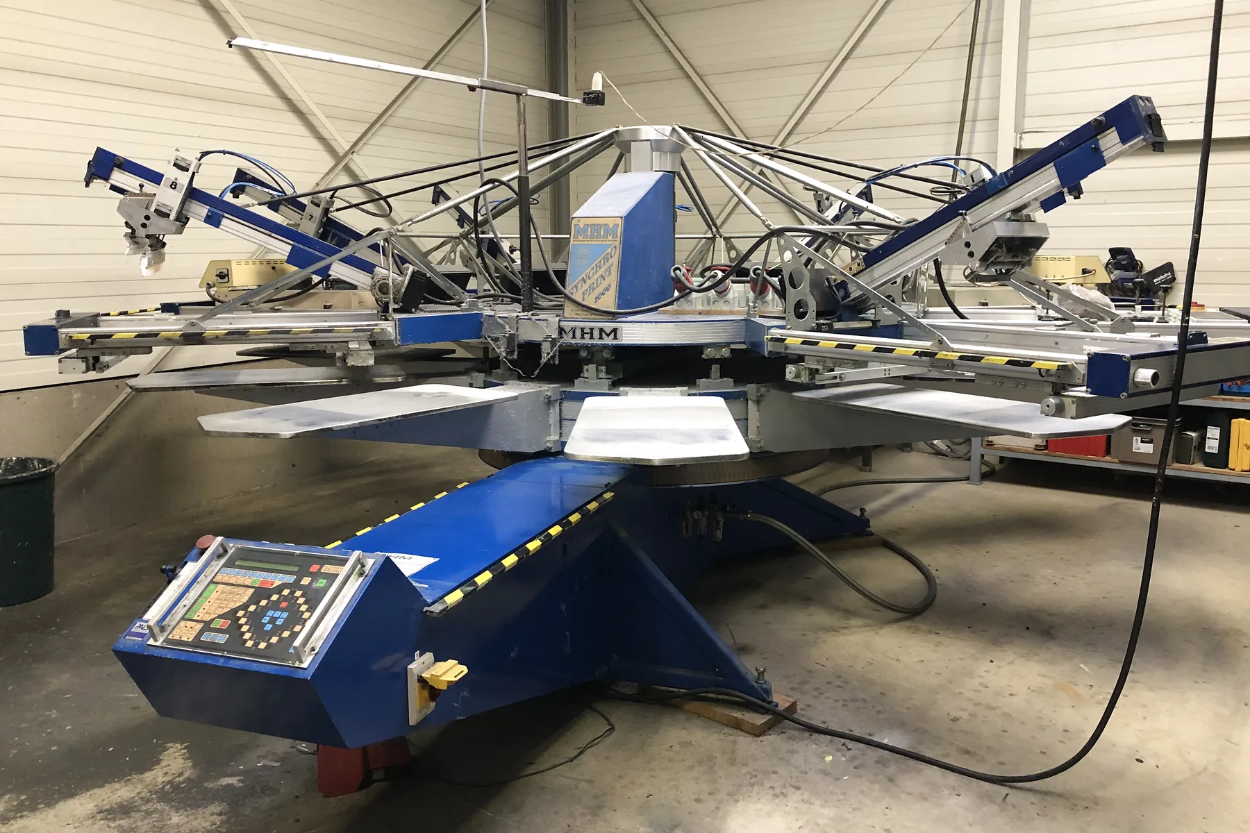 An MHM Synchroprint automatic carousel screen printer in the printing facility